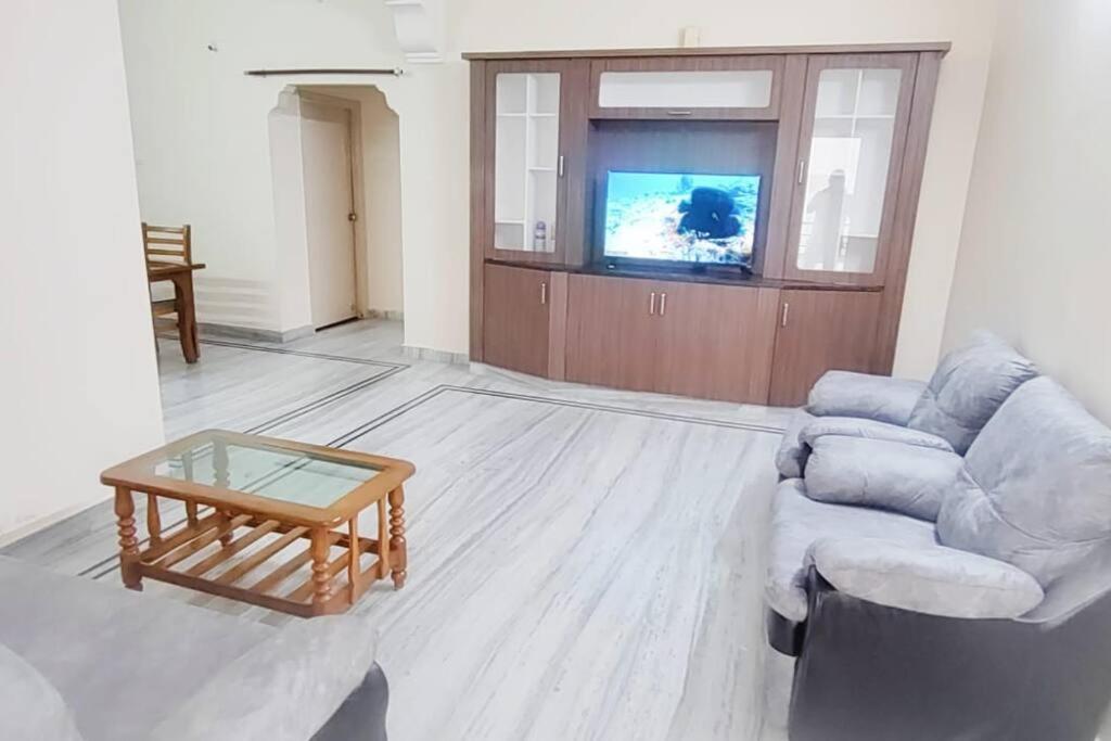 a living room with a couch and a coffee table at 2 BHK Full Furnished in Kukatpally #101 in Hyderabad