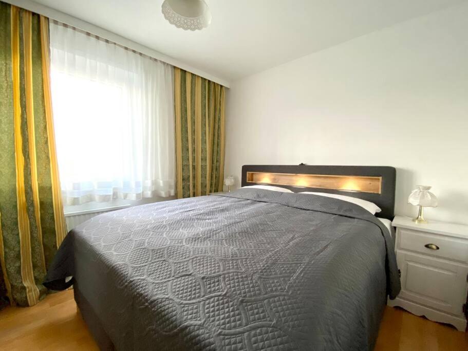a bedroom with a large bed and a window at Near VIC Austria Center, 90sqm, 3BR, LR, Kitchen, 6min to VIC, 10min to City U1 in Vienna