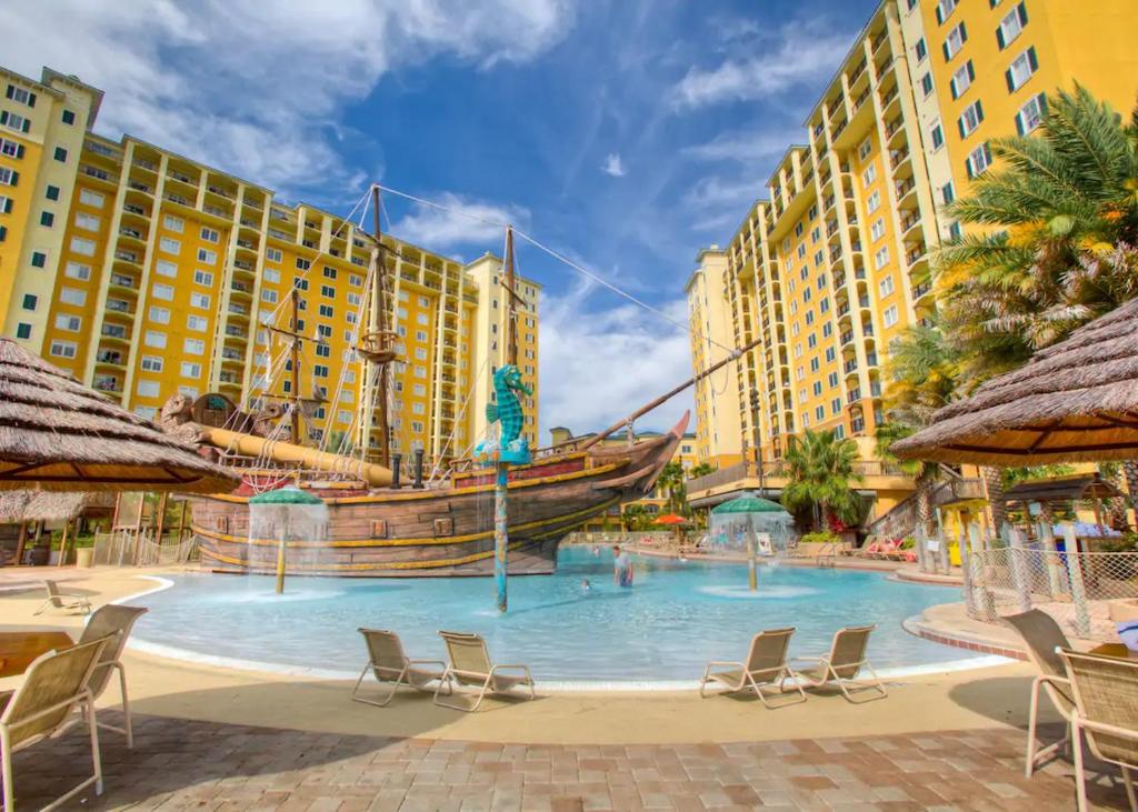a large pool with a pirate ship in the middle at Pirate Ship Resort Condo in Orlando