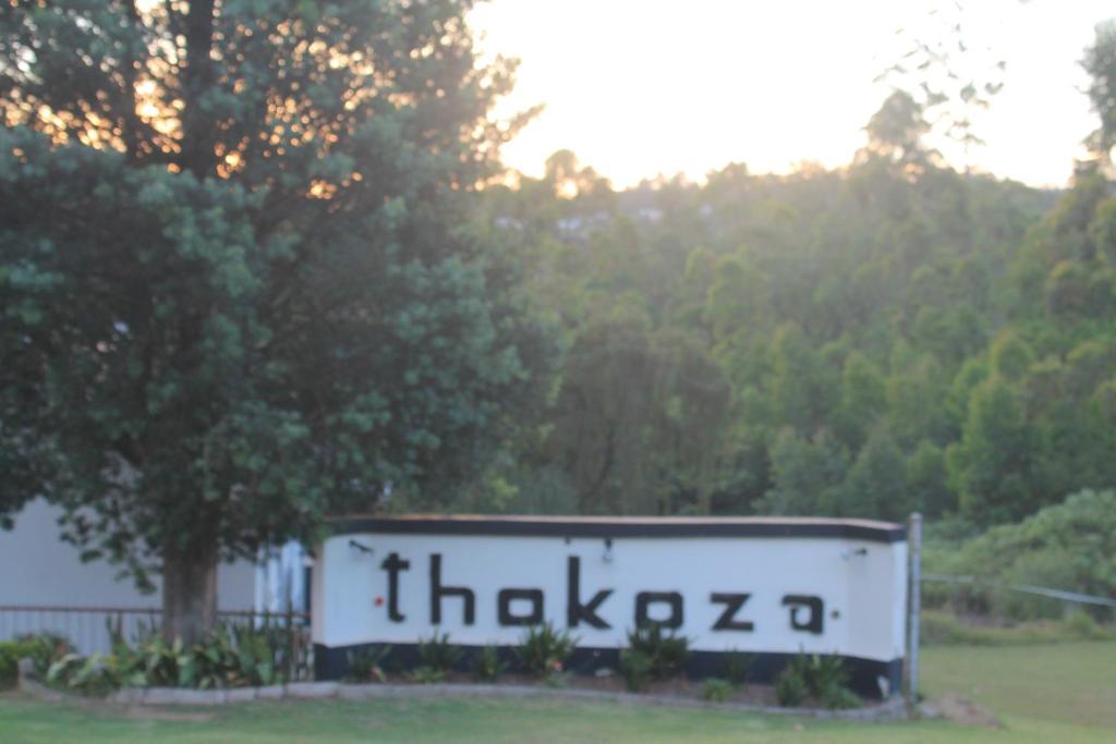 a sign that says thailand on it in a park at Thokoza guest house in Manzini