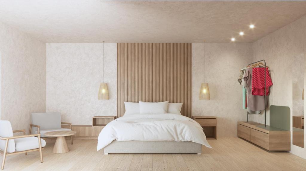 a bedroom with a white bed and a chair at Hotel H4 Cangas 3 Superior in Cangas de Morrazo