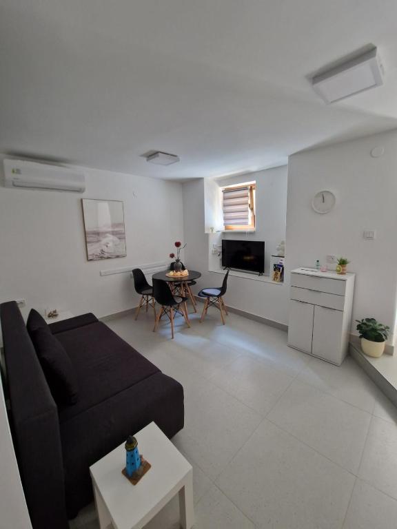 ein Wohnzimmer mit Sofa und Tisch in der Unterkunft ZAD Senj Apartman in Senj