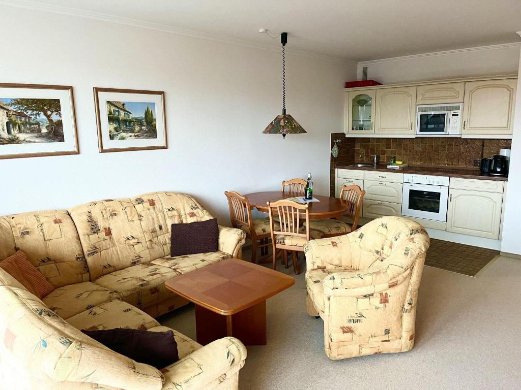 a living room with two couches and a table at Germania-58 in Böhl