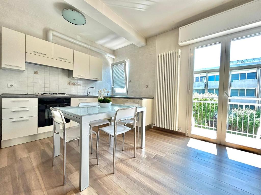 a kitchen with a table and chairs in a room at Nino Bixio Flexrent - Abissinia in Riccione