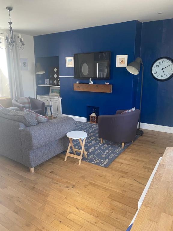 a living room with a couch and a tv at Beach Walk in Berwick-Upon-Tweed