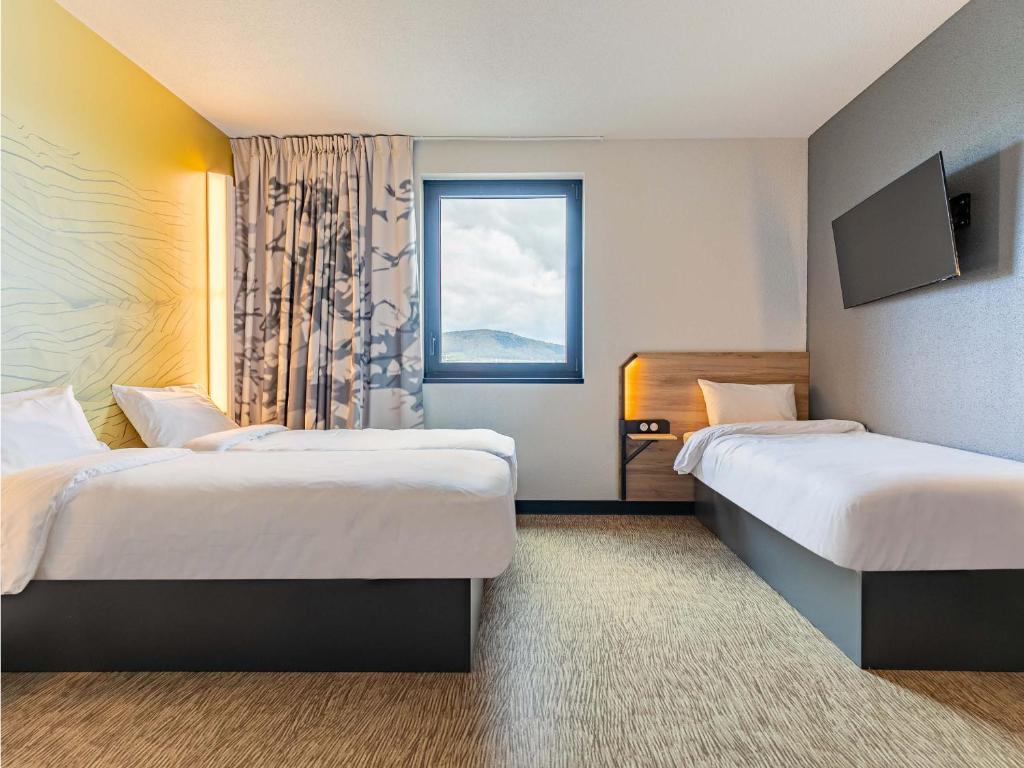 Postel nebo postele na pokoji v ubytování B&B HOTEL Sélestat Centre-Alsace
