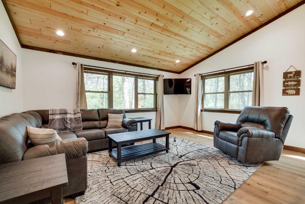 a living room with two couches and a table at Hatfield Vacation Rental with Private Hot Tub! in Merrillan