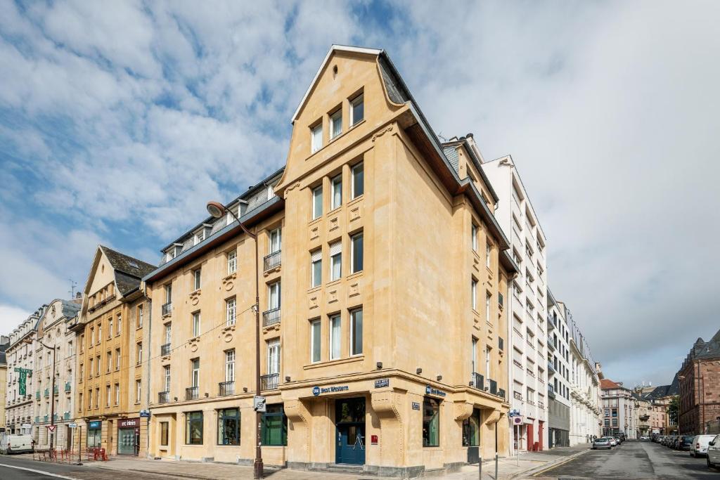 a tall brick building on a city street at Best Western Metz Centre Gare in Metz