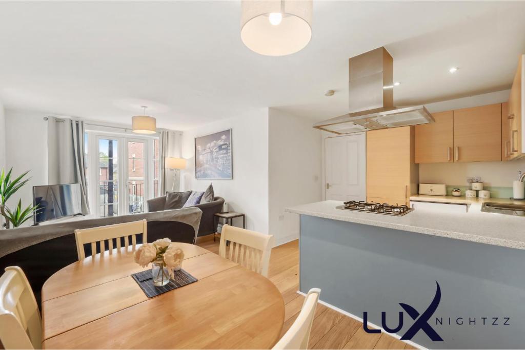 a kitchen and a living room with a table at Luxnightzz - Two Bed - Close to North Station and Hospital in Colchester