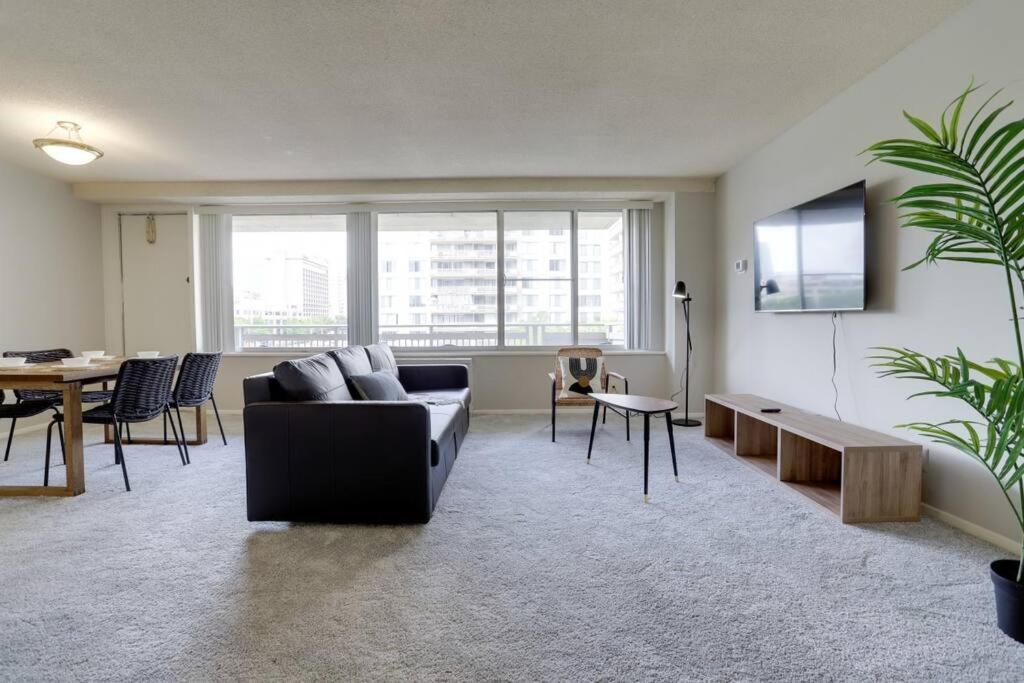 a living room with a couch and a table at Exclusive condo at Crystal City With Gym in Arlington