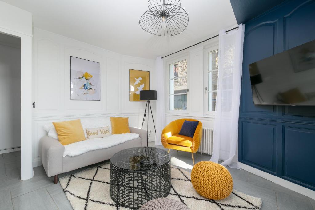 un salon avec un canapé et une télévision dans l'établissement Maison entière Dinan centre - 5 chambres, à Dinan