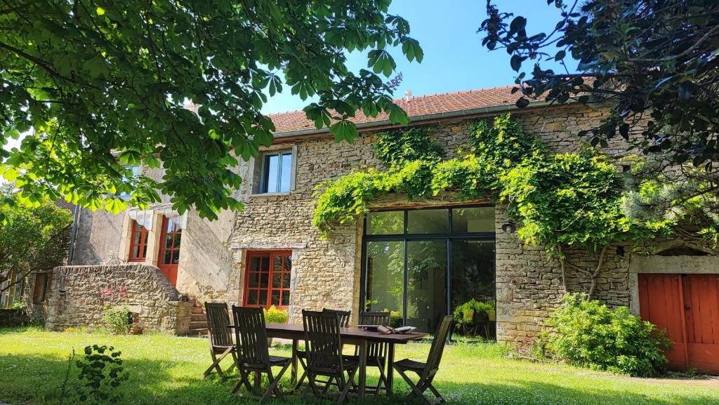 にあるCalme et confort à la campagne en Bourgogne vinicole,の石造りの家の前の椅子