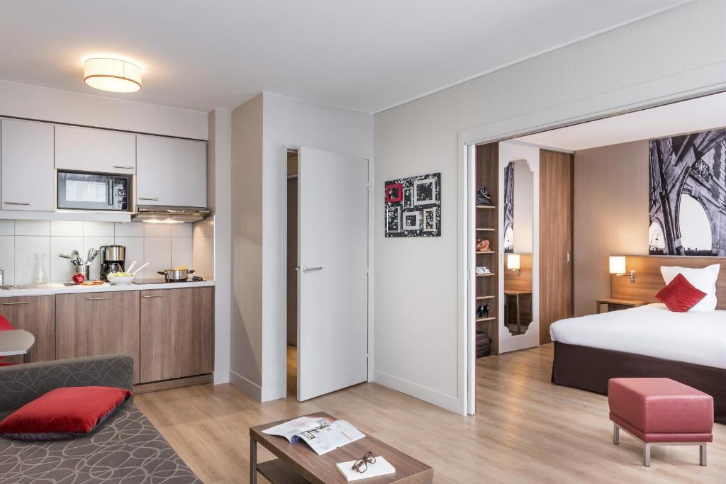 a hotel room with a bed and a kitchen at Aparthotel Adagio Birmingham City Centre in Birmingham