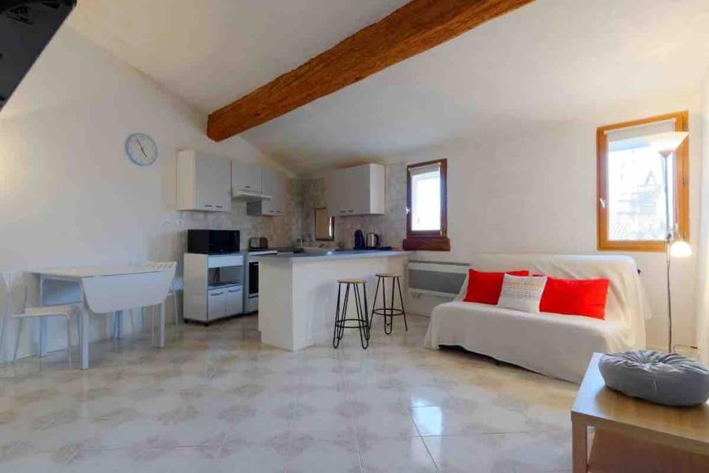 a living room with a couch and a kitchen at La Ciotat : Marius Appartement en duplex très cosy in La Ciotat