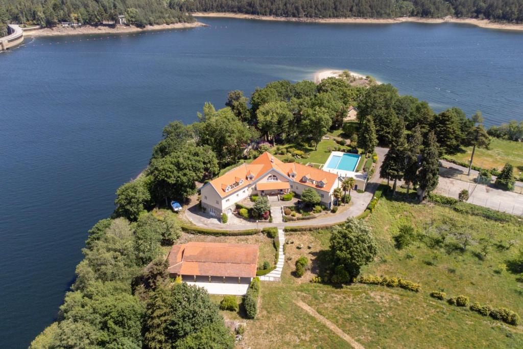 an aerial view of a house on an island in the water at Morgado - River Suites and Houses by PCH in Padrões