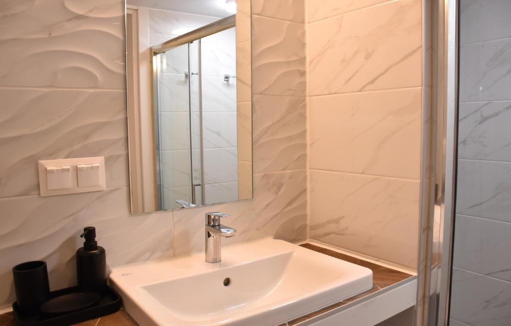 a bathroom with a sink and a mirror at The art studio in Samothráki