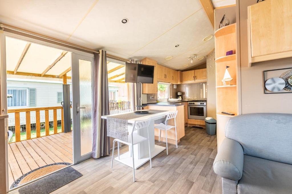 a kitchen and living room in a tiny house at Mobil Home Le Berlin in Noyelles-sur-Mer