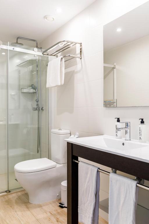 a bathroom with a toilet and a sink and a shower at Mar Hotels Alcanada in Port d'Alcudia