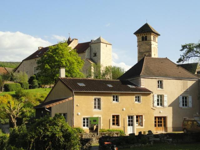 a large house with a tower on top of it at Les chambres de Blanot in Blanot