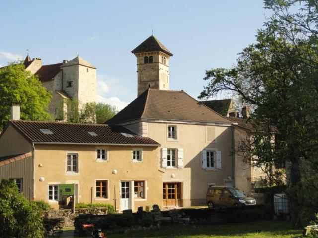 a large house with a tower on top of it at Les chambres de Blanot in Blanot