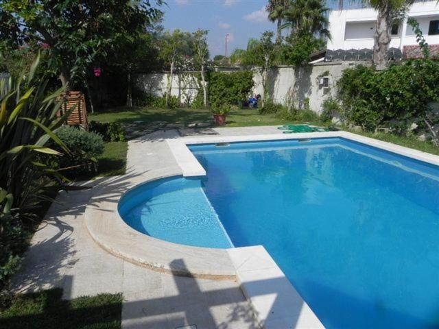 a large blue swimming pool next to a house at villa Annarè in Torre dell'Orso