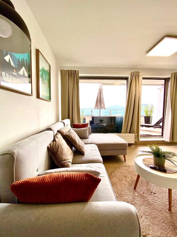 a living room with a couch and a table at Bukove Love in Wisła