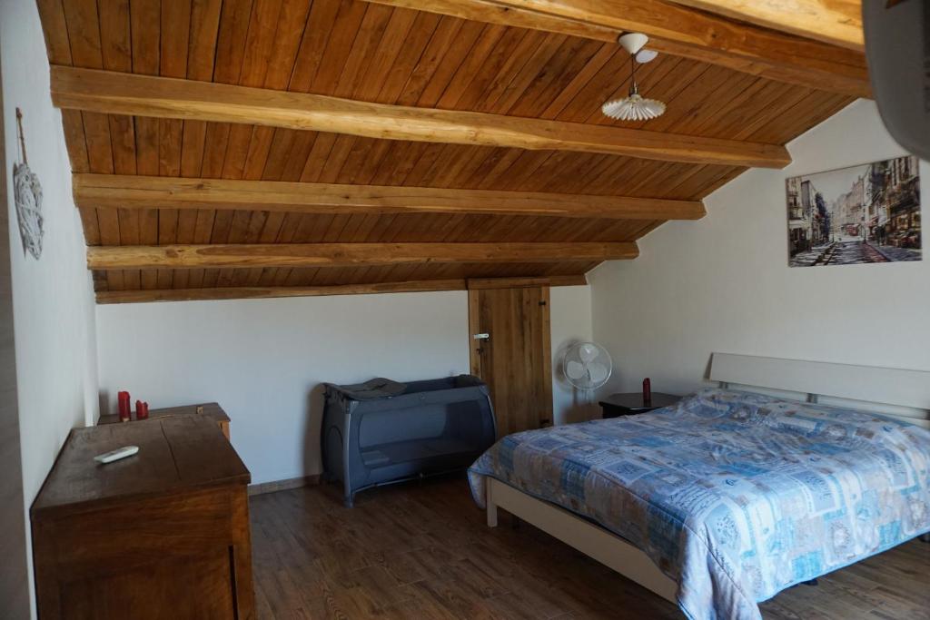 a bedroom with a bed and a wooden ceiling at Casa Selvaggia in Badolato