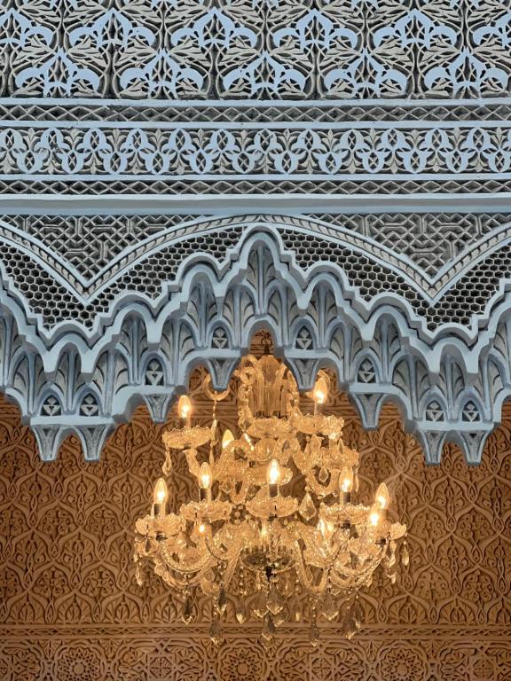 a chandelier hanging from a ceiling in a building at Riad Del Rey in Rabat