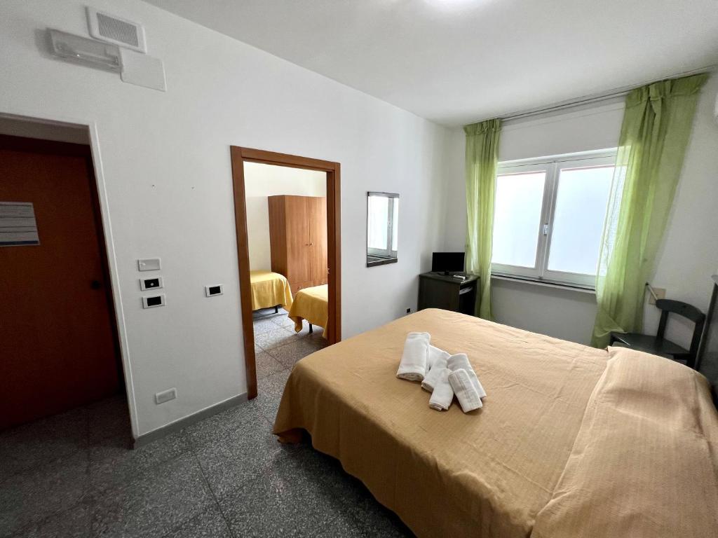 Postel nebo postele na pokoji v ubytování Hotel Minerva