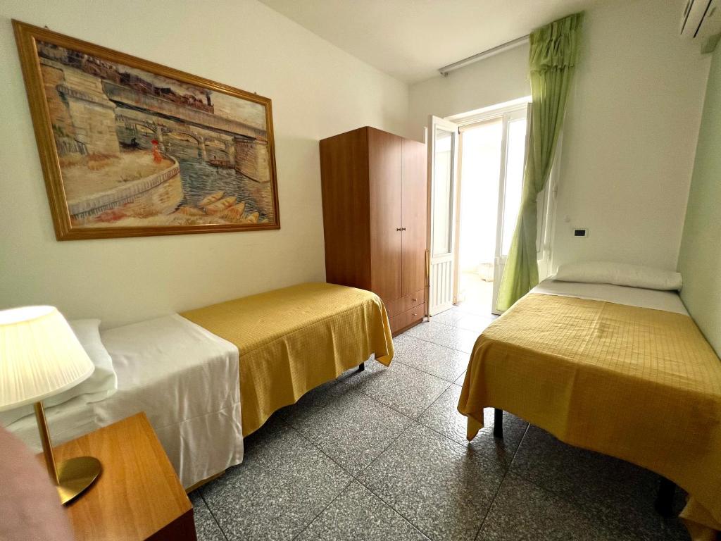 Postel nebo postele na pokoji v ubytování Hotel Minerva