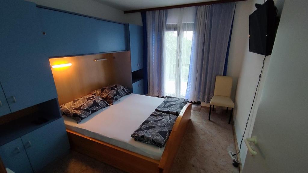 a bedroom with a bed with a blue wall at House Bosko Best place for everyone 