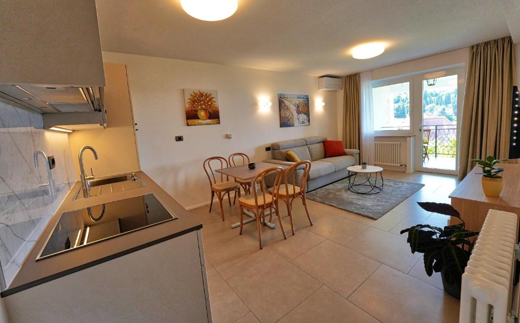 a kitchen and living room with a table and a couch at Apartments Bagar in Portorož