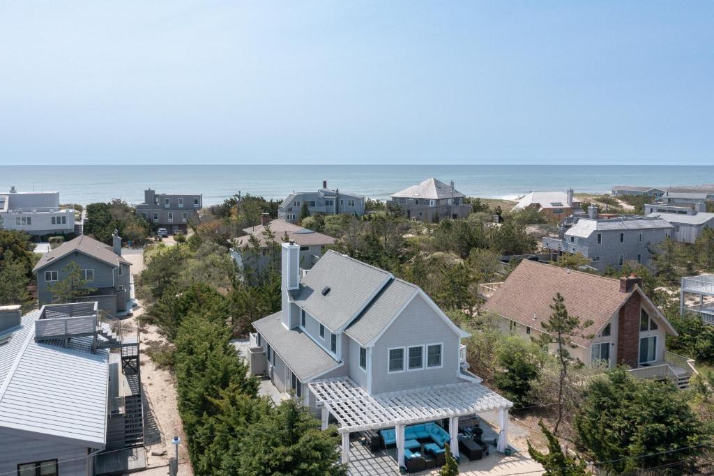 an aerial view of a neighborhood with houses and the ocean at Beach House in Amagansett