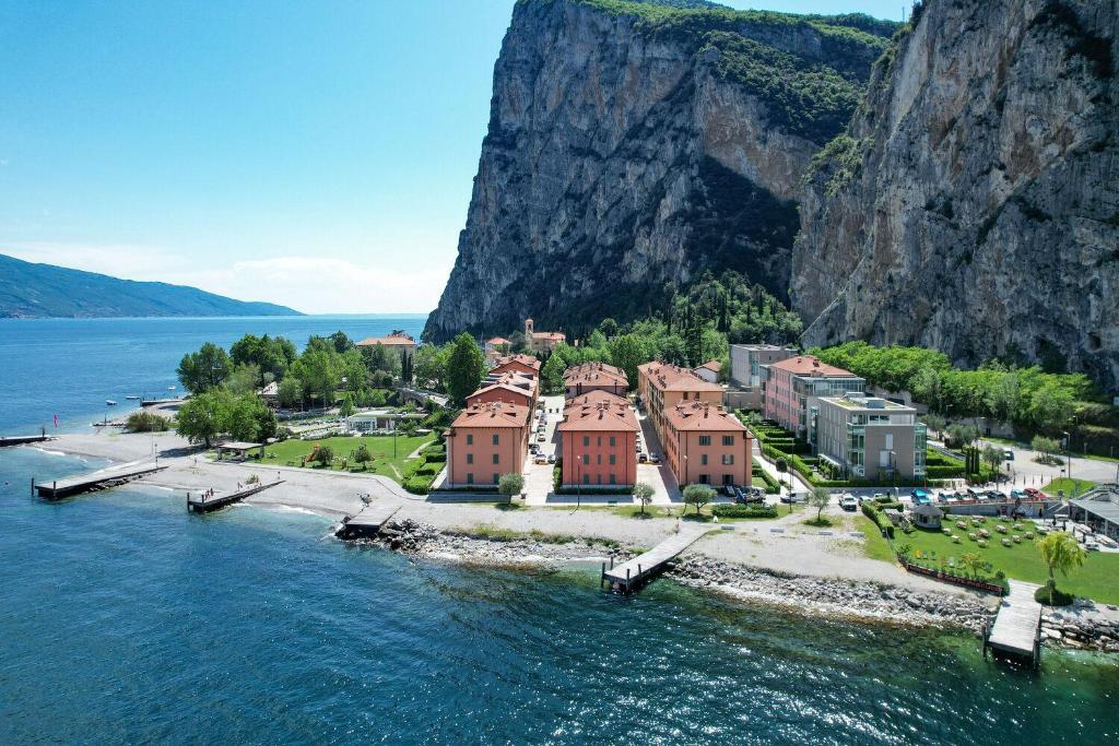 una isla en el agua al lado de una montaña en Sail Home, en Campione del Garda