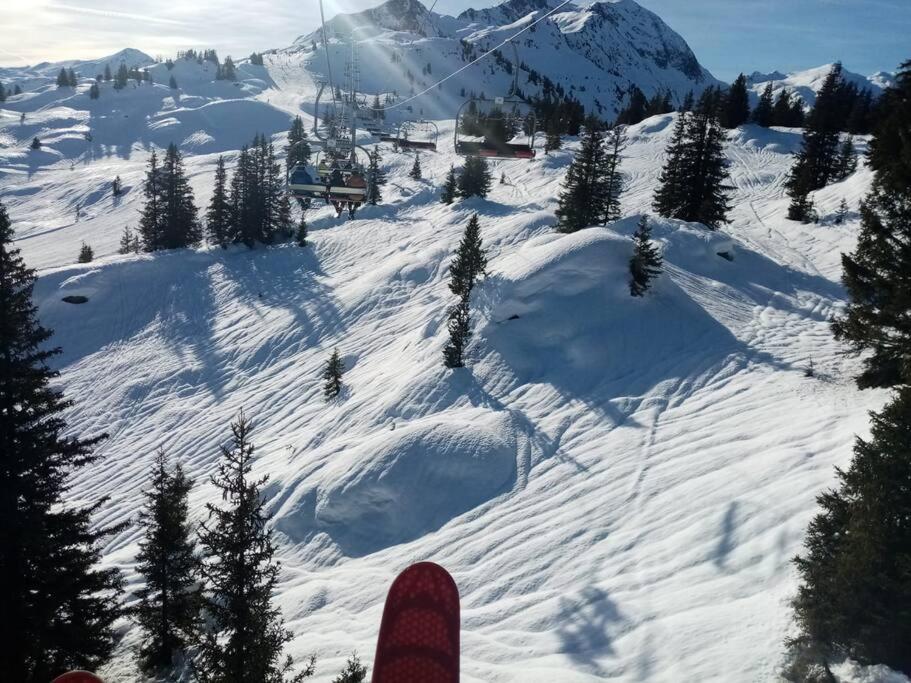 a person standing on a snow covered ski slope at L'appartement LES BOSSONS en lisière de forêt dans le chalet Génépi in Arêches-Beaufort