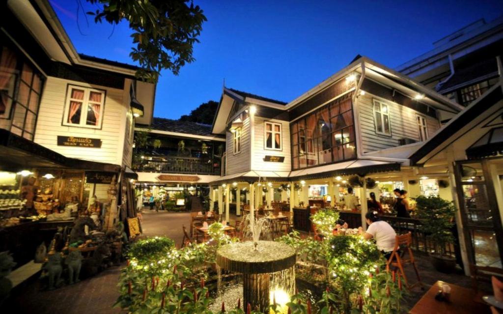 a building with a fountain in the middle of a courtyard at Silom Village Inn in Bangkok