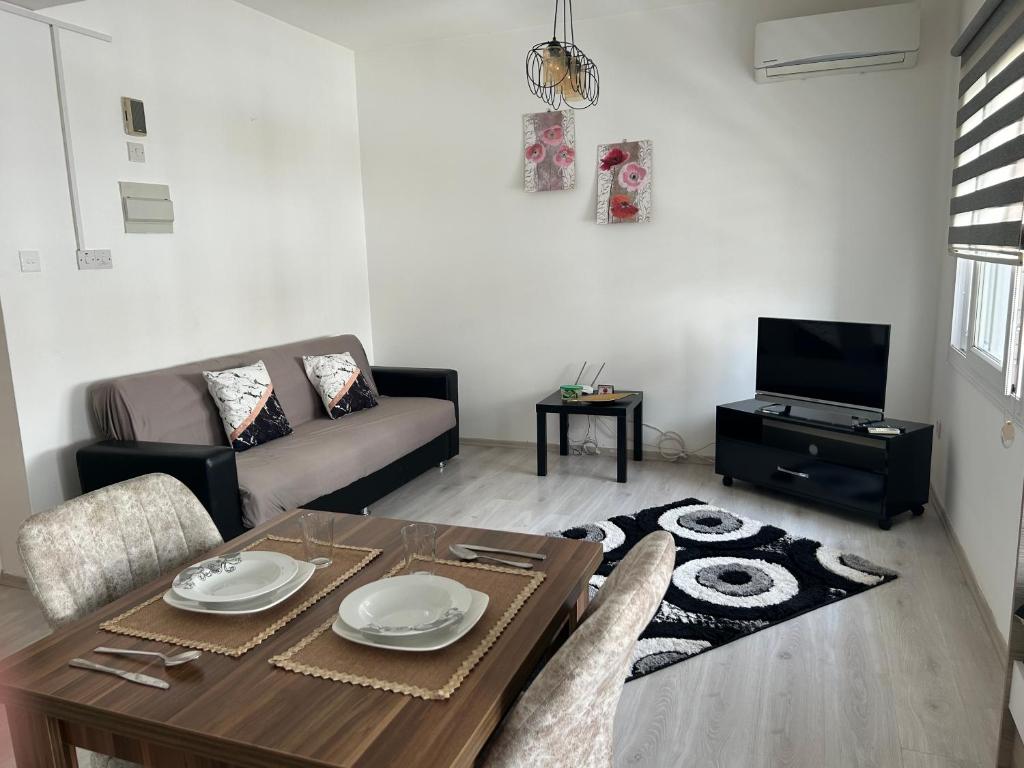 a living room with a table and a couch at New studio no2 in the middle off famagusta & NETFLIX in Famagusta