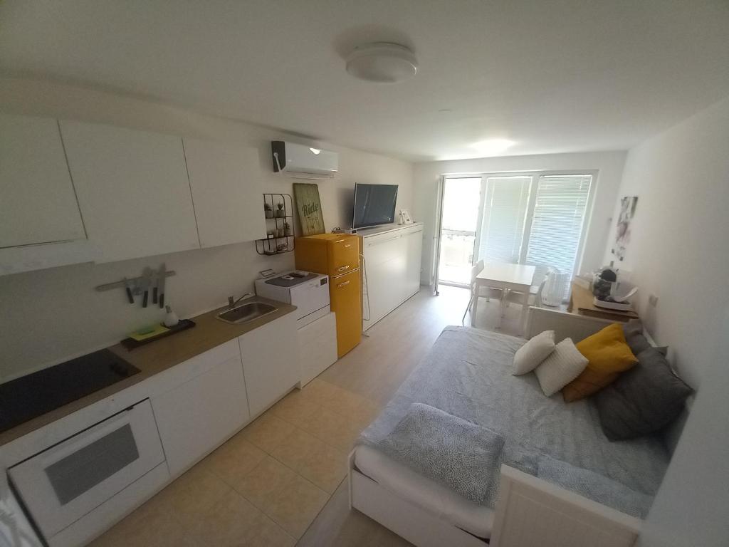 uma sala de estar com uma cozinha e um sofá em Apartma DU32 em Moravske-Toplice