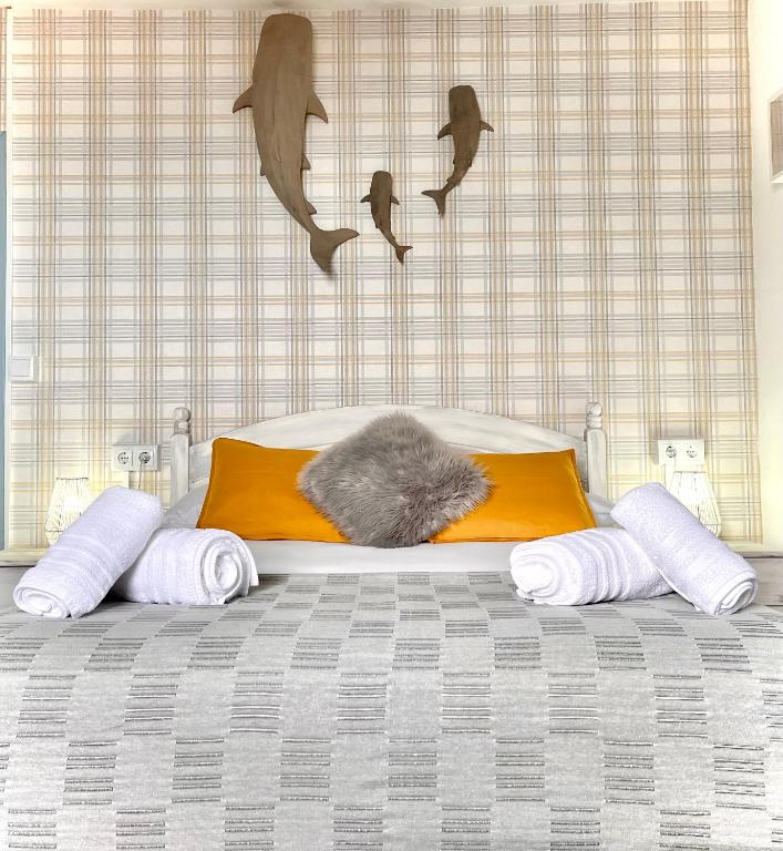 a bed with a cat sleeping on top of it at AL SON DE LAS OLAS in Lastres