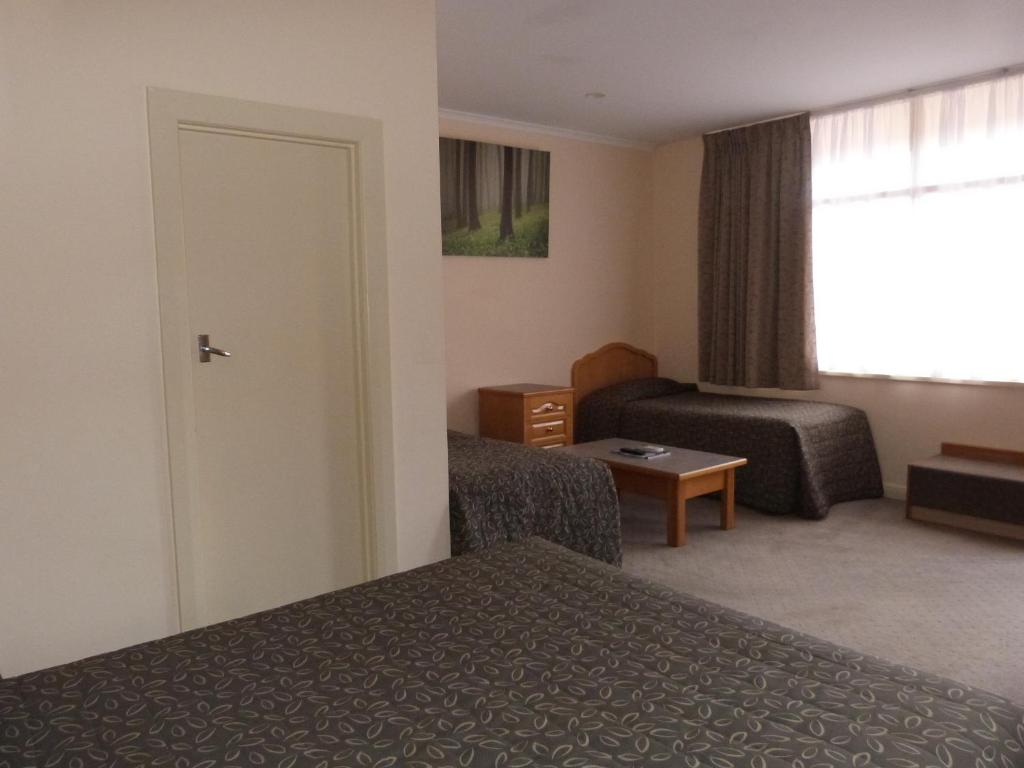 Postel nebo postele na pokoji v ubytování Glenelg Motel