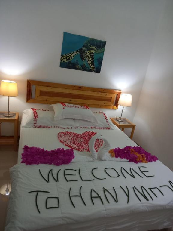 Postel nebo postele na pokoji v ubytování Kaafu Inn Guraidhoo