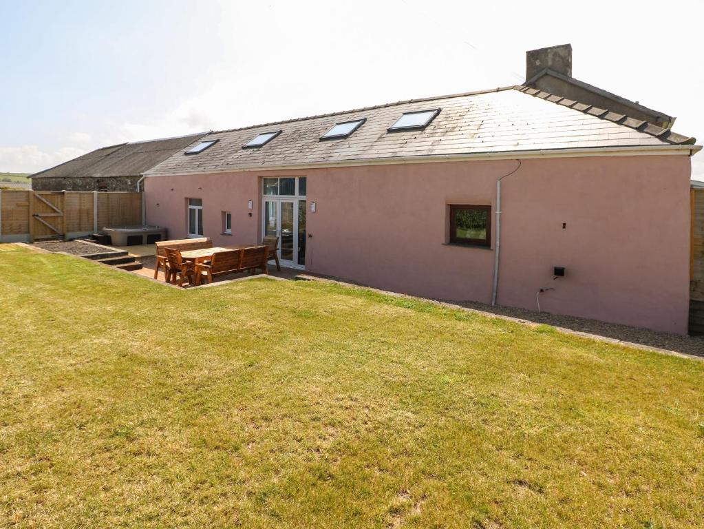 a house with a grassy yard in front of it at Y Felin in Haverfordwest
