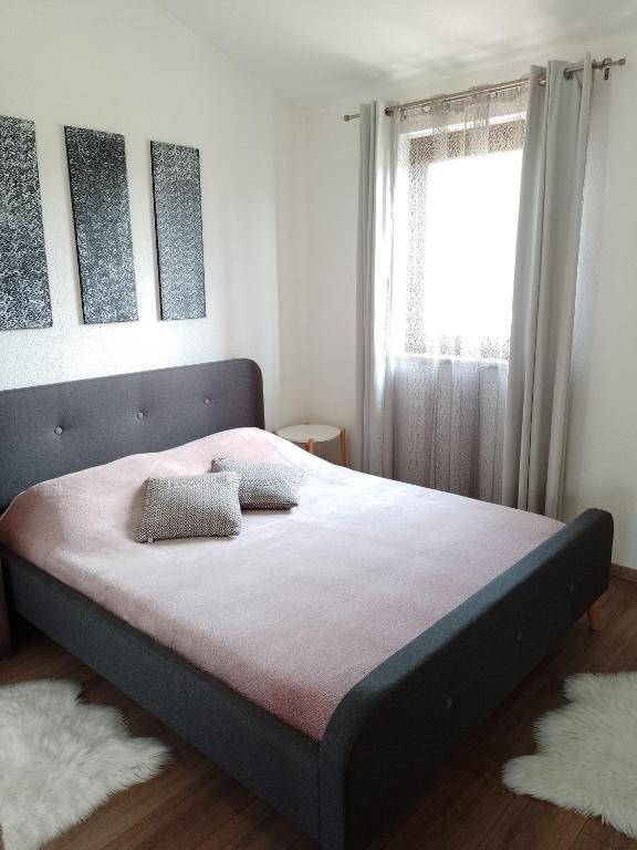 a large bed in a bedroom with a window at MARTINA 2 in Bašanija