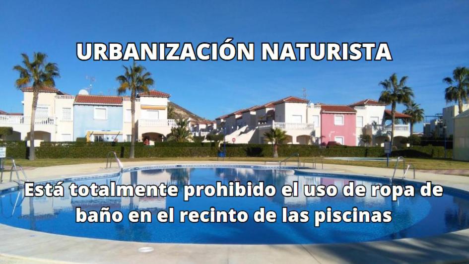 a sign for a swimming pool in front of some houses at Torremar Natura 532 in Vera