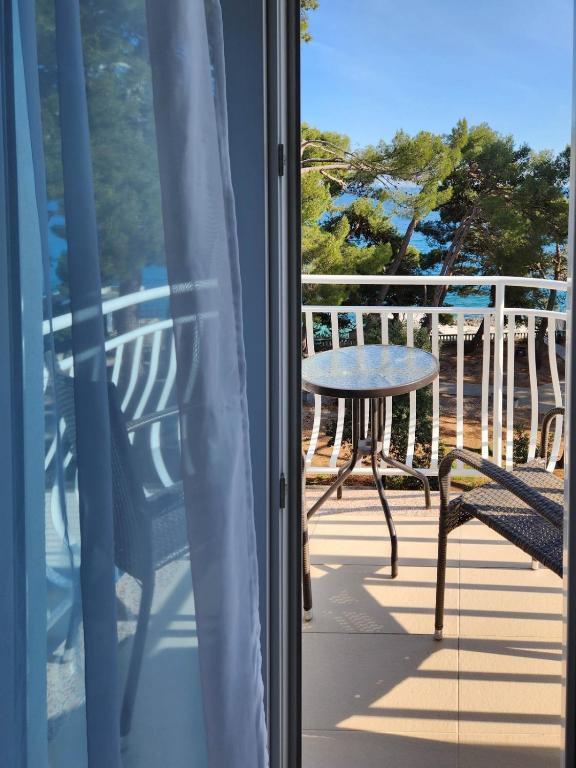 a view of a table and chairs on a balcony at Hotel Bor in Krk