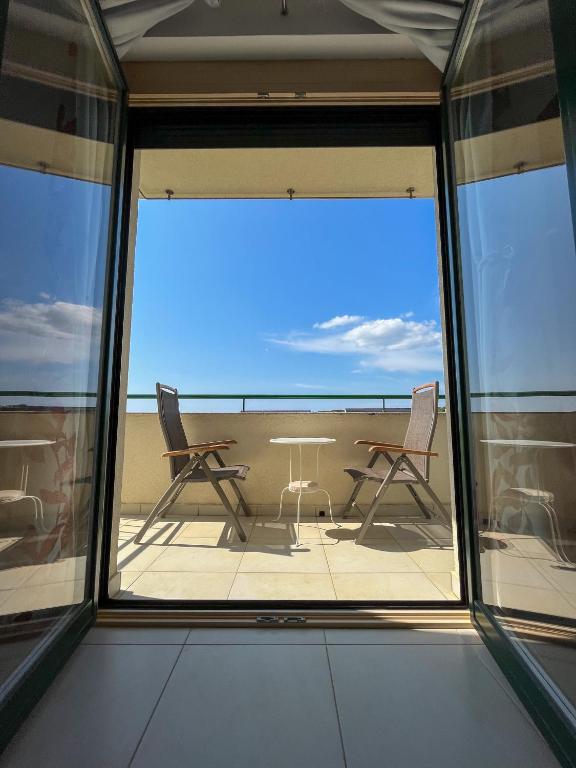 a view of a balcony with a table and chairs at Mandre Island Pag in Mandre