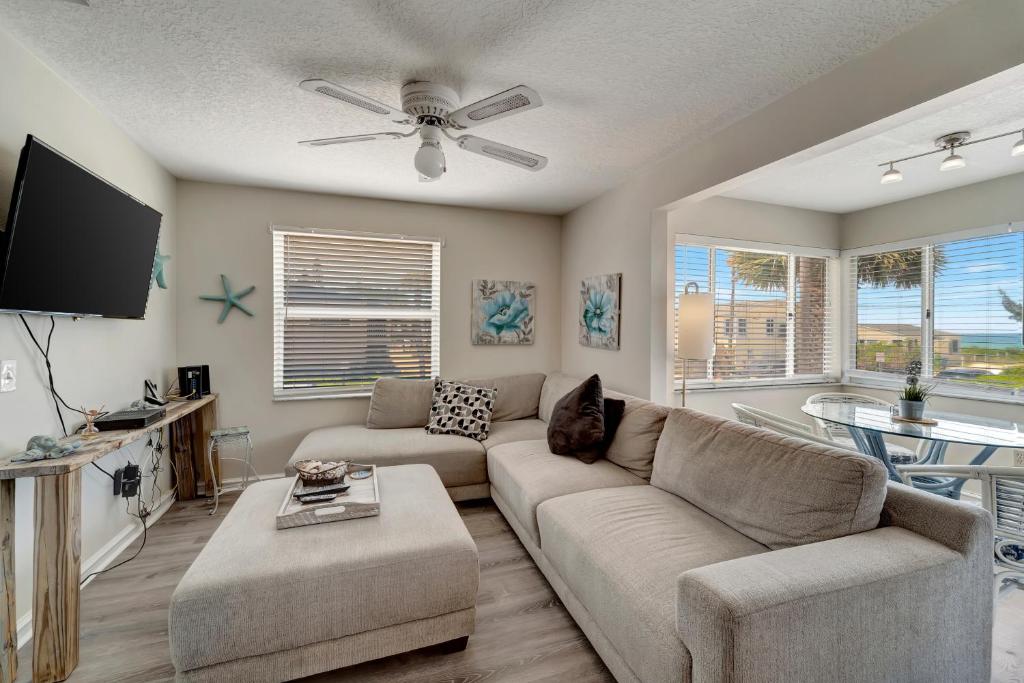 a living room with a couch and a flat screen tv at Ocean View in Holmes Beach