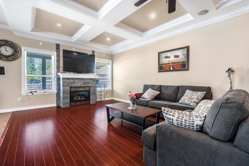a living room with a couch and a fireplace at Share Home 1BD suite in Coquitlam in Coquitlam