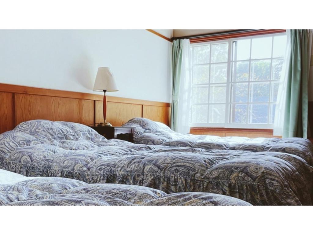 Кровать или кровати в номере Hakuba Pension Meteor - Vacation STAY 63322v