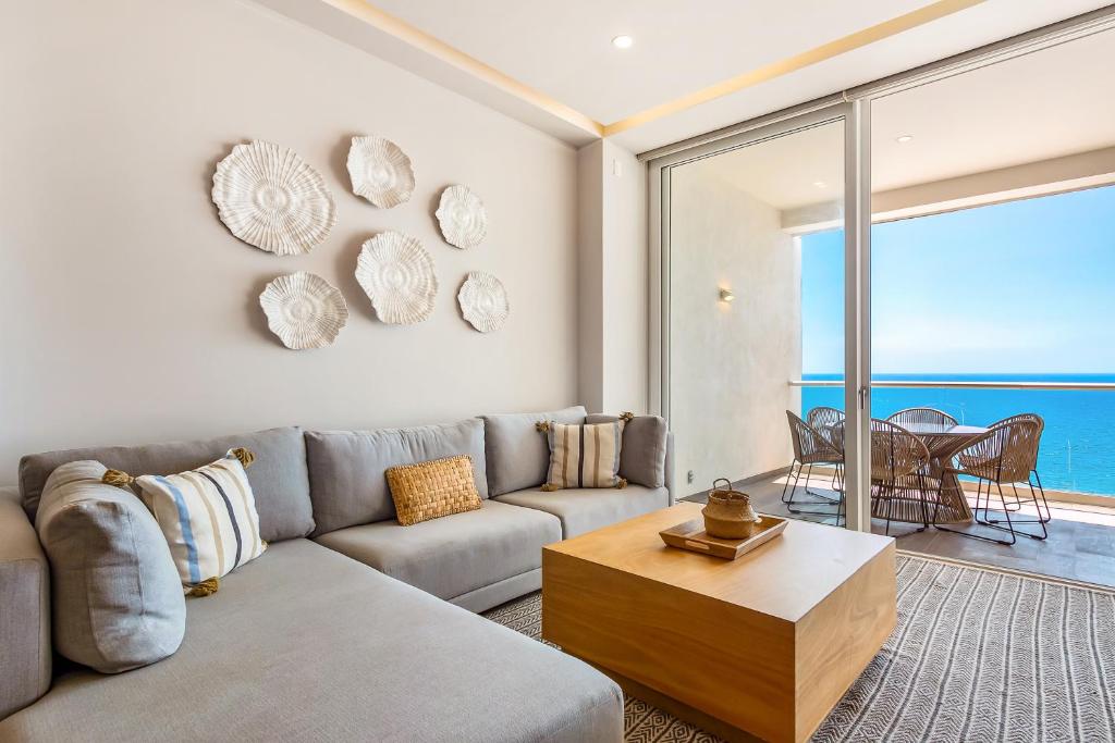 a living room with a couch and a table at Harbor 171 Oceanfront Residences #13011 in Puerto Vallarta